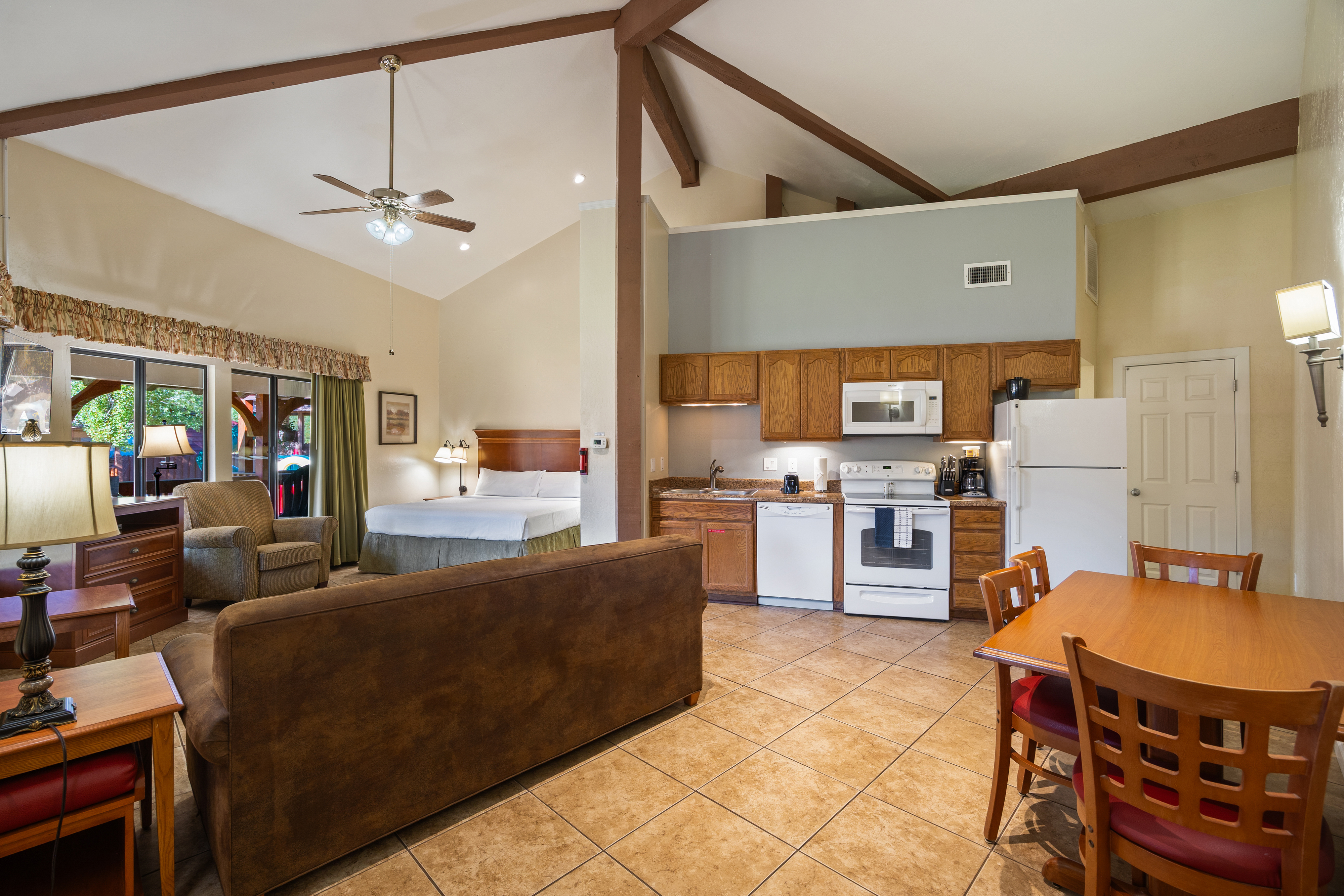 Studio suite with exposed beam ceiling, full kitchen, and living area